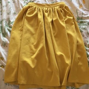 Yellow, below the knee skirt.